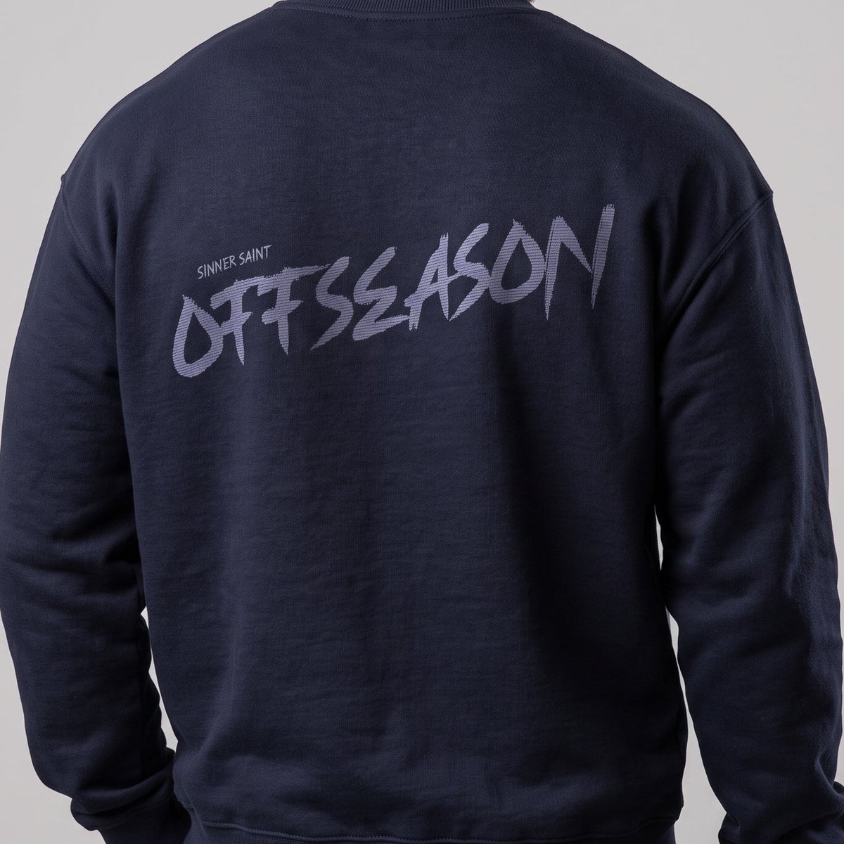 An oversized bodybuilding sweater in navy blue saying "OFFSEASON"